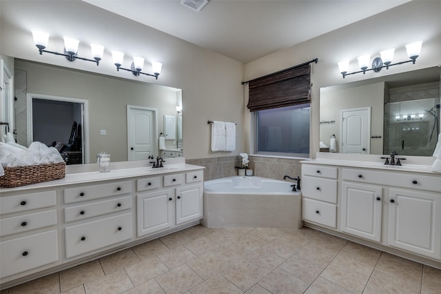 bathroom with two vanities, a shower stall, tile patterned flooring, and a sink
