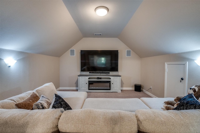living area with lofted ceiling, visible vents, baseboards, and light carpet