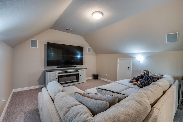 home theater room with lofted ceiling, visible vents, and light carpet