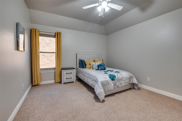 bedroom featuring vaulted ceiling, a ceiling fan, baseboards, and light carpet
