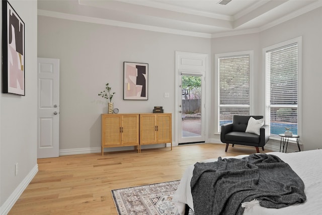 bedroom with crown molding, access to exterior, multiple windows, and light wood-style floors