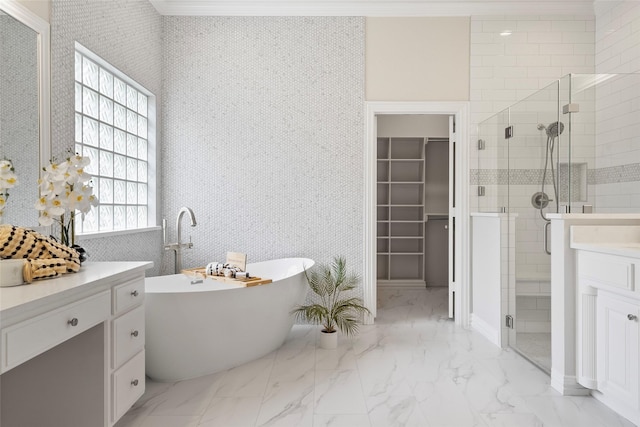 bathroom with vanity, a stall shower, a walk in closet, a freestanding bath, and marble finish floor