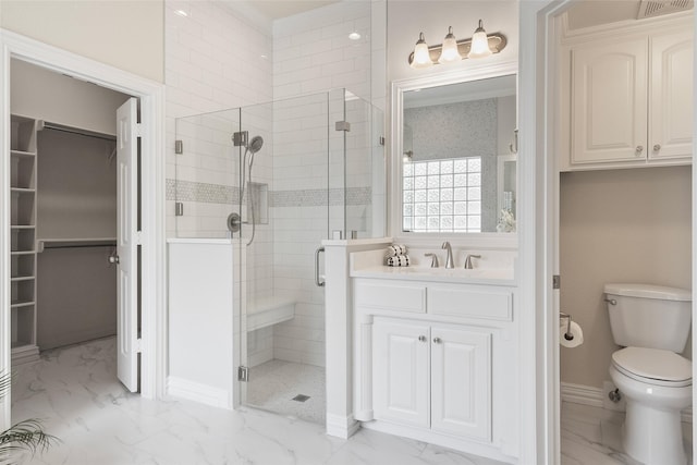 full bath featuring vanity, a stall shower, a spacious closet, toilet, and marble finish floor