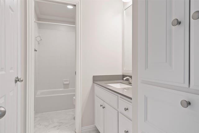 bathroom featuring vanity, toilet, shower / bath combination, marble finish floor, and baseboards