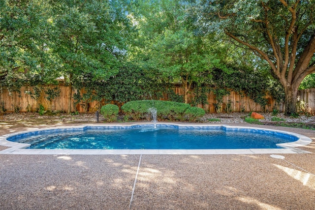 view of pool featuring fence