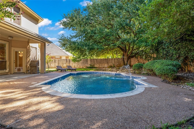 view of pool with a patio area, a fenced backyard, and a fenced in pool