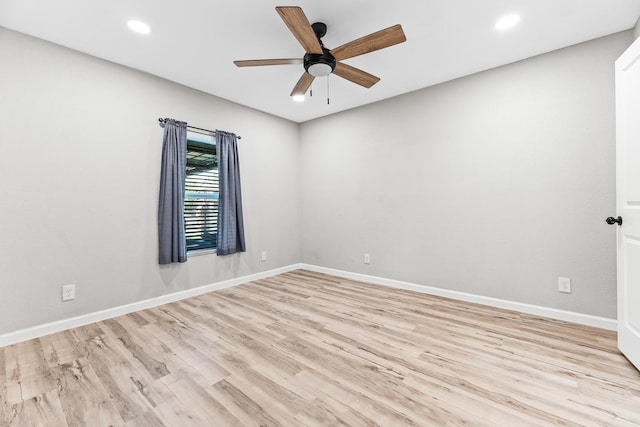 spare room with baseboards, a ceiling fan, wood finished floors, and recessed lighting