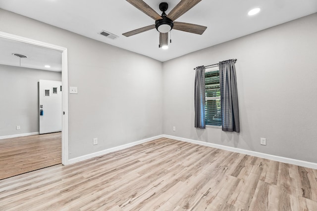 empty room featuring baseboards, a ceiling fan, wood finished floors, and visible vents