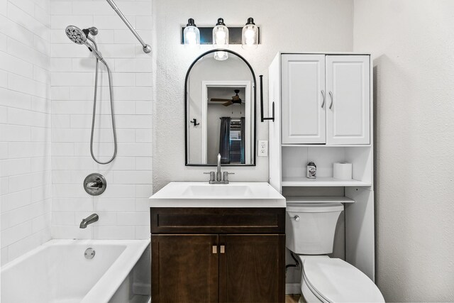 full bathroom with a ceiling fan, tub / shower combination, vanity, and toilet