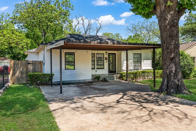 bungalow-style home with fence, a porch, and driveway