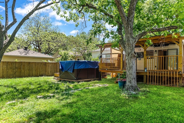 view of yard featuring a wooden deck and fence