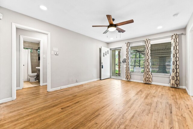 empty room with recessed lighting, light wood-style floors, a ceiling fan, and baseboards
