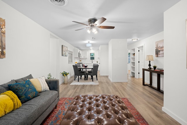 811 N Cooper St, Arlington, TX 76011 - living area featuring ceiling fan, light wood-style floors, and baseboards
