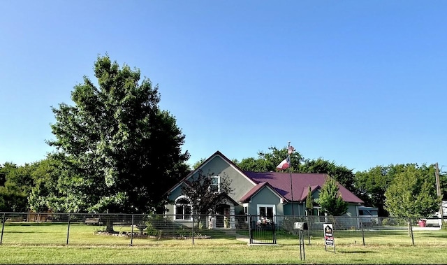view of front of property with fence and a front lawn