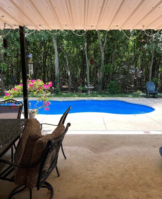 outdoor pool featuring a patio and outdoor dining area
