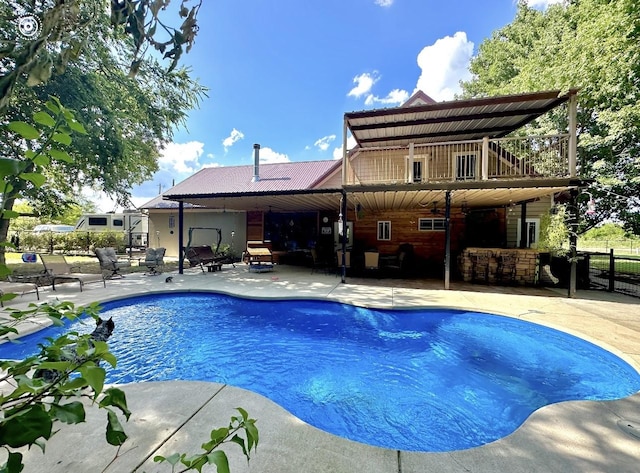 pool with a patio and fence
