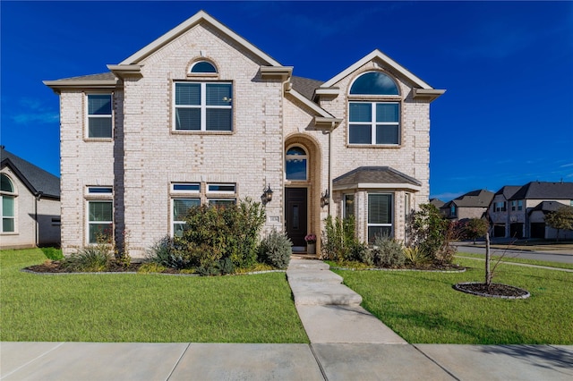 1036 Rutherford St, Frisco, TX 75036 - traditional home featuring brick siding and a front lawn