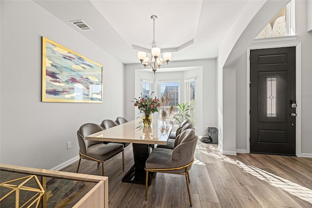 1036 Rutherford St, Frisco, TX 75036 - dining area featuring an inviting chandelier, wood finished floors, a tray ceiling, visible vents, and baseboards