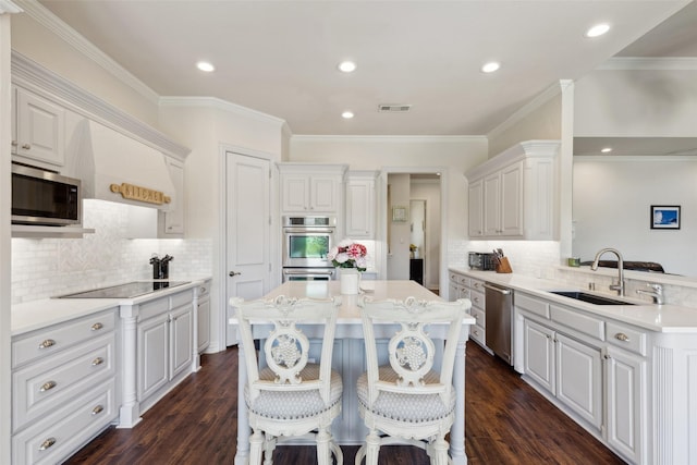 5205 Coral Springs Dr, Flower Mound, TX 75022 - kitchen with a sink, stainless steel appliances, light countertops, decorative backsplash, and ornamental molding