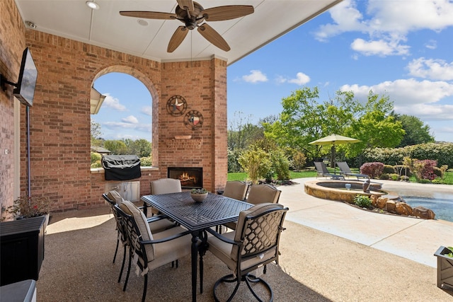 5205 Coral Springs Dr, Flower Mound, TX 75022 - view of patio / terrace with an outdoor brick fireplace, ceiling fan, outdoor dining space, and a pool with connected hot tub