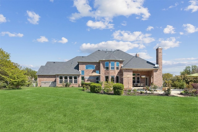 5205 Coral Springs Dr, Flower Mound, TX 75022 - rear view of house with brick siding, a yard, a chimney, and roof with shingles