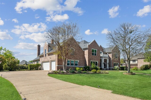 5205 Coral Springs Dr, Flower Mound, TX 75022 - traditional home featuring brick siding, a garage, concrete driveway, a chimney, and a front yard