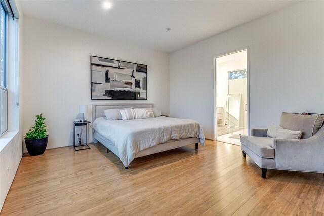 4401 Roseland Ave Unit A, Dallas, TX 75204 - bedroom featuring light wood finished floors and ensuite bath