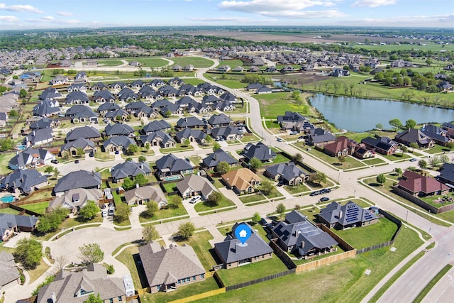 drone / aerial view featuring a residential view and a water view