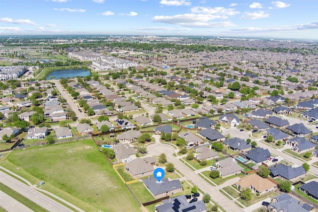 drone / aerial view featuring a residential view and a water view