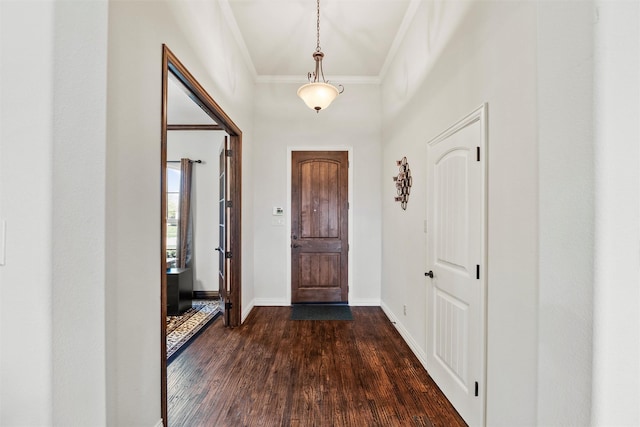 entrance foyer with dark wood-type flooring, baseboards, and crown molding
