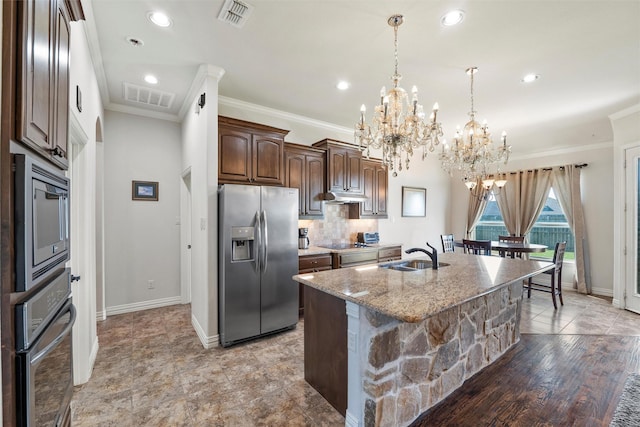 kitchen featuring an inviting chandelier, visible vents, a sink, and appliances with stainless steel finishes
