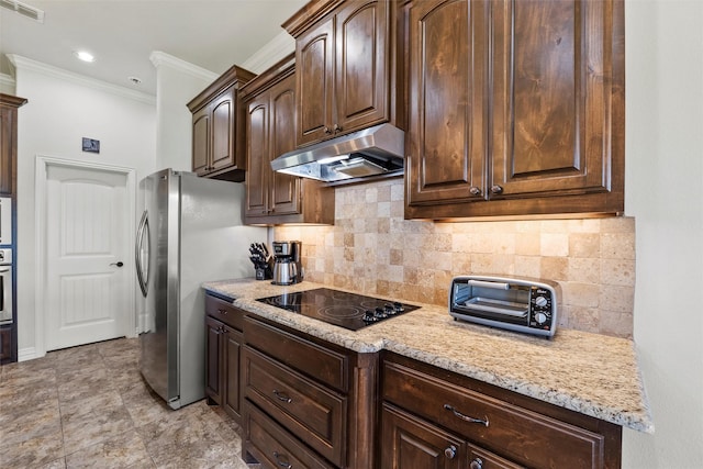 kitchen with dark brown cabinetry, under cabinet range hood, visible vents, decorative backsplash, and appliances with stainless steel finishes