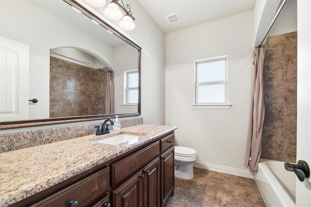 bathroom with plenty of natural light, vanity, visible vents, and toilet
