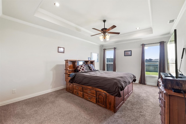 carpeted bedroom with a raised ceiling, baseboards, multiple windows, and visible vents