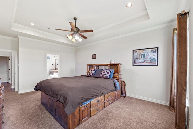 bedroom featuring a tray ceiling, baseboards, ornamental molding, and carpet