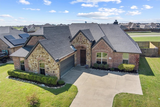 view of front facade featuring a shingled roof, brick siding, stone siding, and a front lawn