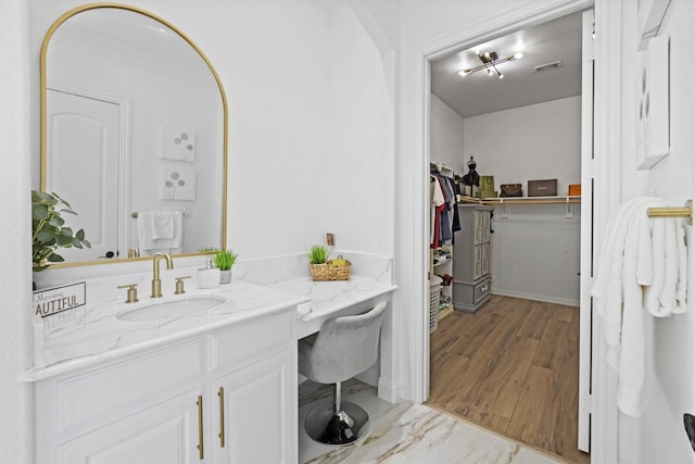 847 Bentwater Pkwy, Grand Prairie, TX 75104 - bathroom featuring vanity, a spacious closet, and wood finished floors