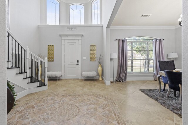 847 Bentwater Pkwy, Grand Prairie, TX 75104 - entrance foyer with ornamental molding, stairs, a towering ceiling, and baseboards