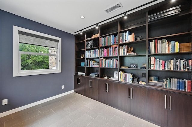 sitting room featuring visible vents, baseboards, tile patterned floors, and track lighting