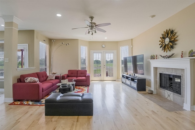 232 Wilshire Dr, Coppell, TX 75019 - living room with baseboards, light wood finished floors, a fireplace, and a ceiling fan