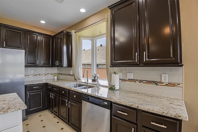 232 Wilshire Dr, Coppell, TX 75019 - kitchen featuring tasteful backsplash, light stone counters, recessed lighting, appliances with stainless steel finishes, and a sink