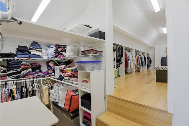 232 Wilshire Dr, Coppell, TX 75019 - walk in closet featuring vaulted ceiling and wood finished floors