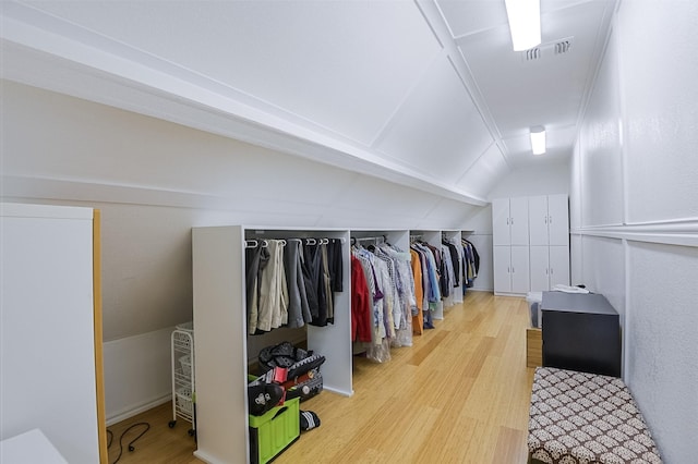 232 Wilshire Dr, Coppell, TX 75019 - spacious closet with visible vents, wood finished floors, and lofted ceiling