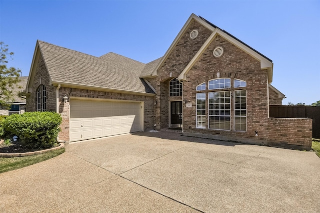 232 Wilshire Dr, Coppell, TX 75019 - view of front of property with brick siding, a shingled roof, a garage, and concrete driveway