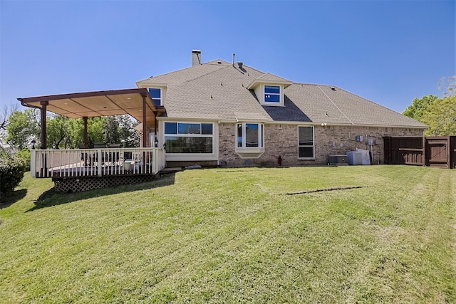 232 Wilshire Dr, Coppell, TX 75019 - rear view of house with a lawn, roof with shingles, brick siding, a chimney, and a deck