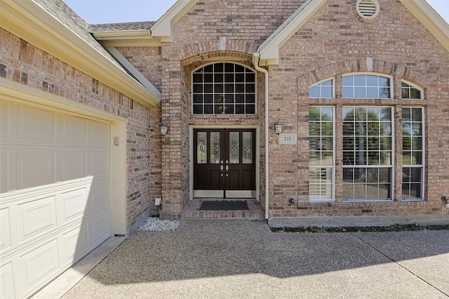 232 Wilshire Dr, Coppell, TX 75019 - property entrance featuring a garage and brick siding