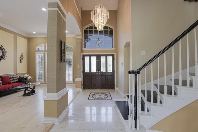 232 Wilshire Dr, Coppell, TX 75019 - tiled foyer featuring baseboards, a chandelier, stairway, a high ceiling, and arched walkways