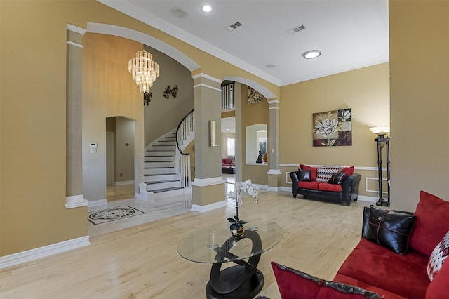 232 Wilshire Dr, Coppell, TX 75019 - living area featuring ornamental molding, visible vents, ornate columns, arched walkways, and wood finished floors