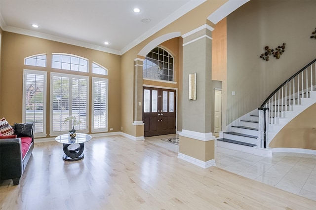 232 Wilshire Dr, Coppell, TX 75019 - foyer entrance featuring ornate columns, crown molding, plenty of natural light, and arched walkways