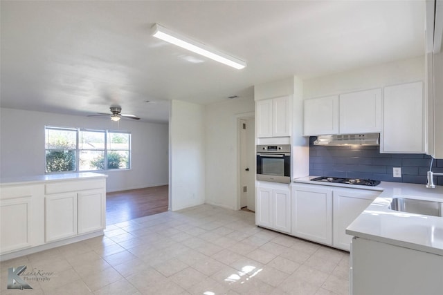 2326 N Mockingbird Ln, Abilene, TX 79603 - kitchen with oven, a sink, backsplash, gas cooktop, and under cabinet range hood